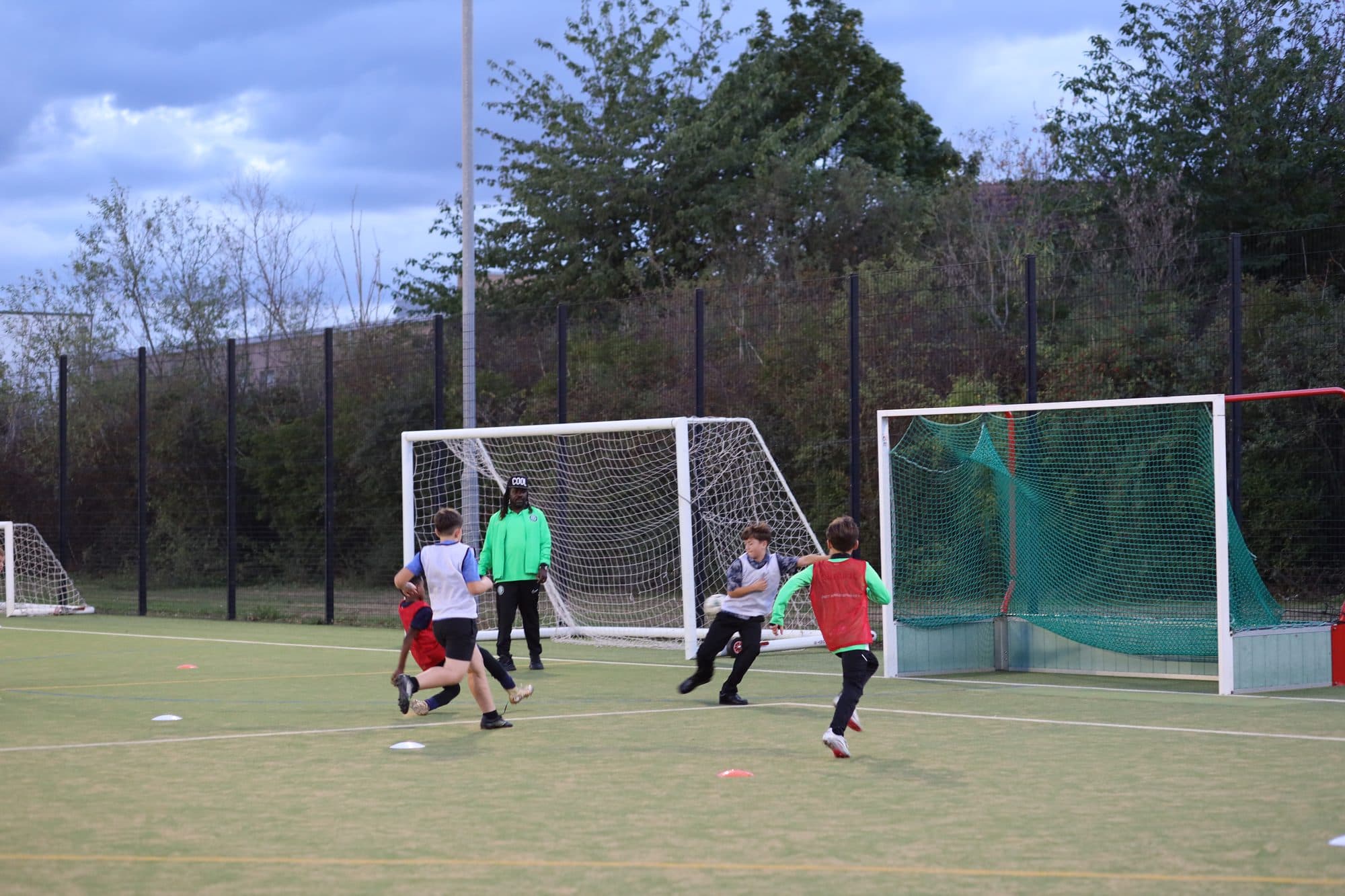 Goalmouth action during an evening small-sided game